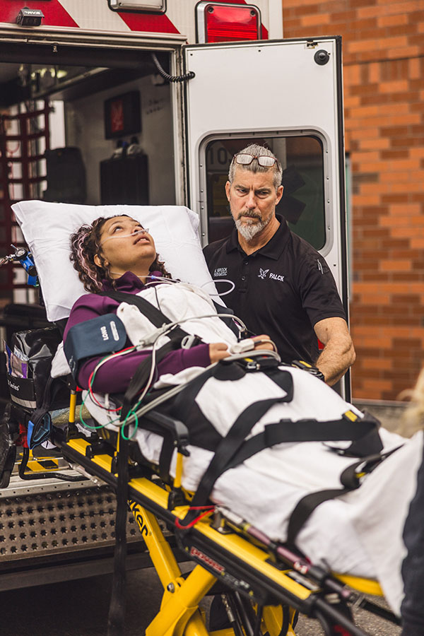 patient on stretcher coming out of ambulance